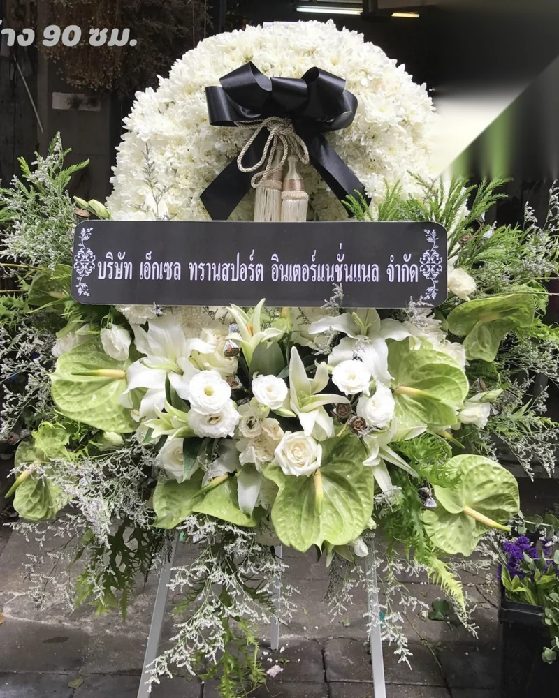 ป้ายพวงหรีดดอกไม้สดตั้งหน้าศาลาวัดในกรุงเทพฯ